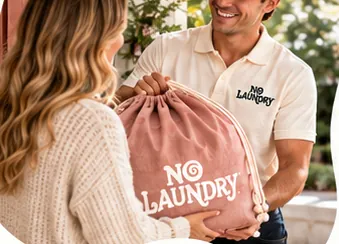 A NoLaundry driver collects a pink NoLaundry bag from a customer at her door